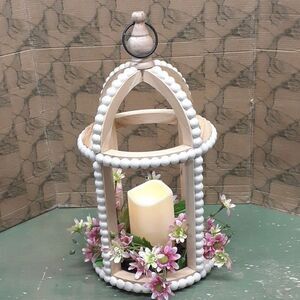 MCM lighted gazebo with floral garden at base.